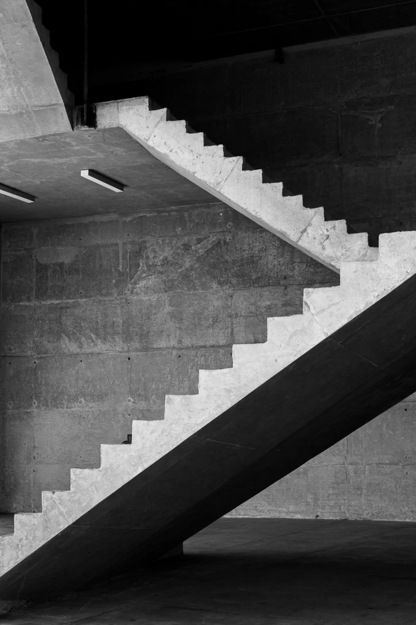 grayscale photo of concrete staircase