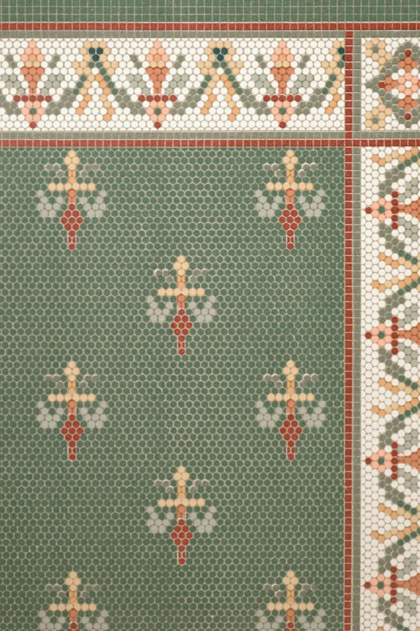 Green mosaic tile with ornate border pattern