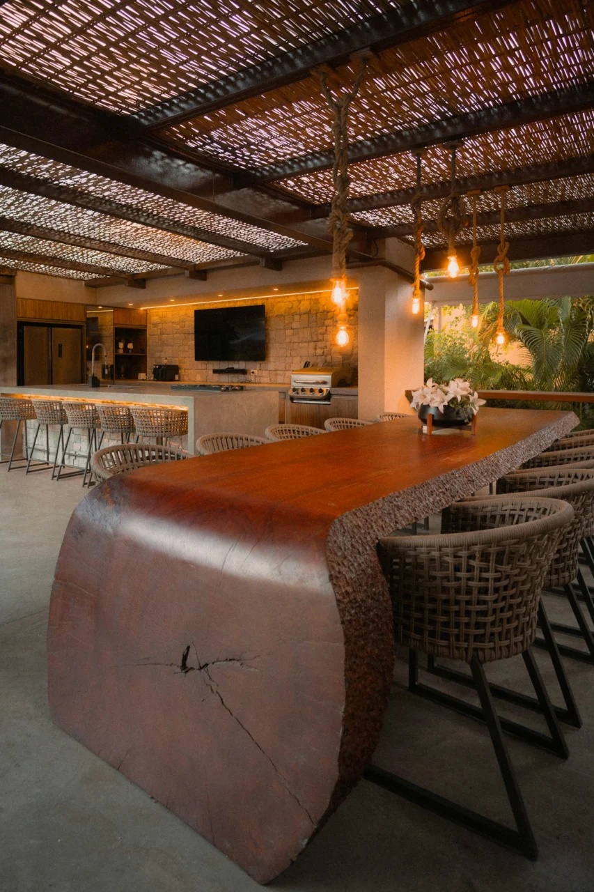 Large wooden table with chairs in outdoor dining area