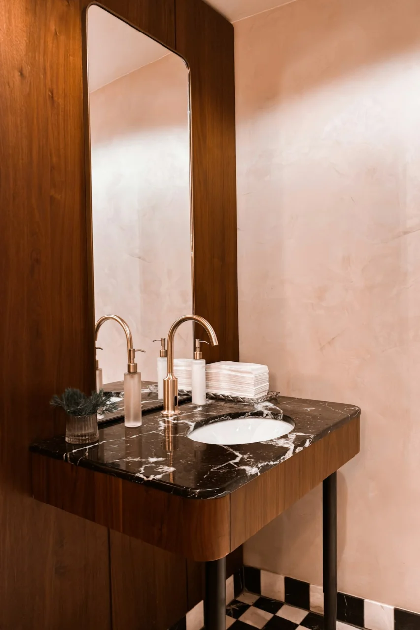 Modern bathroom vanity with marble countertop and brass fixtures