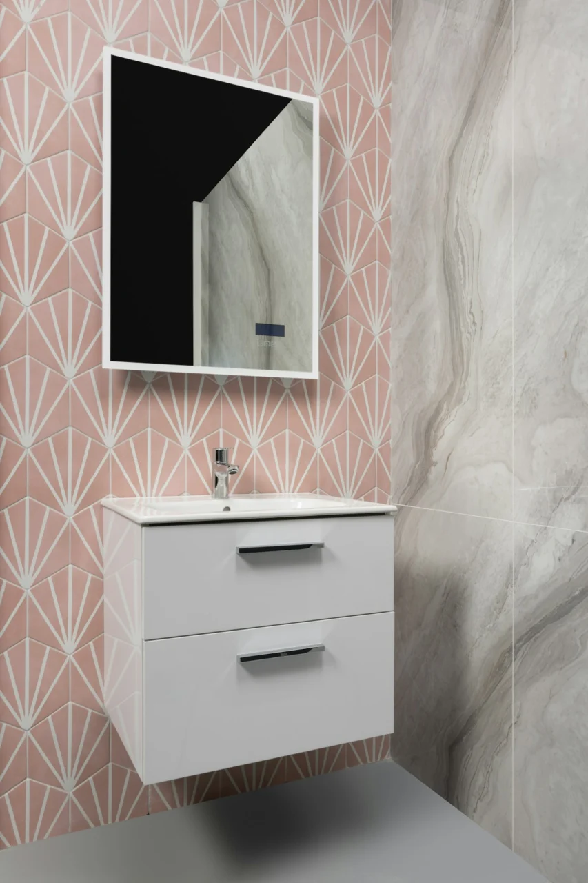Modern bathroom with pink geometric tiles, vanity, and mirror