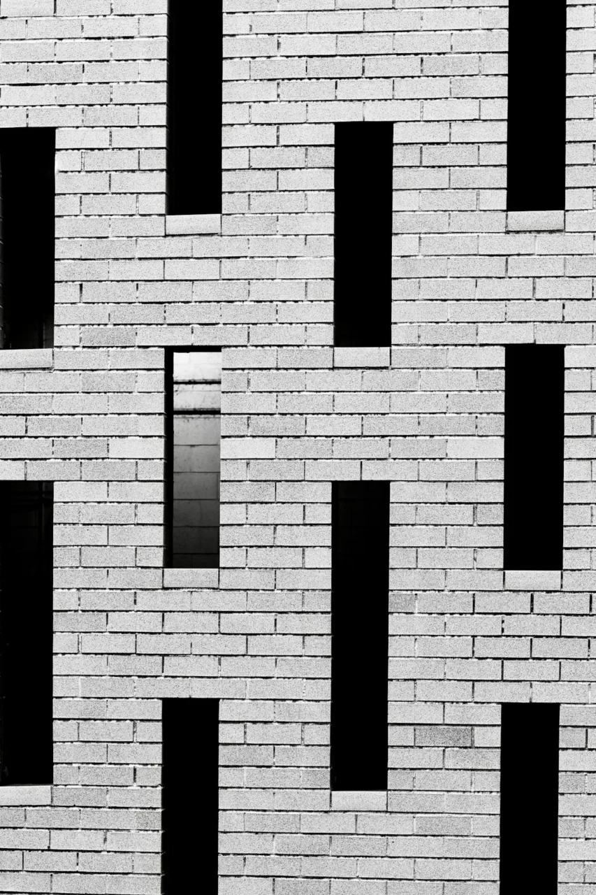 Modern brick building facade with vertical dark windows