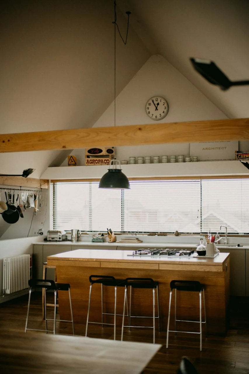 Modern kitchen island with bar stools and large window