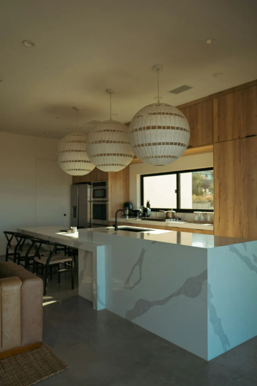 Modern kitchen island with pendant lights and wooden cabinets