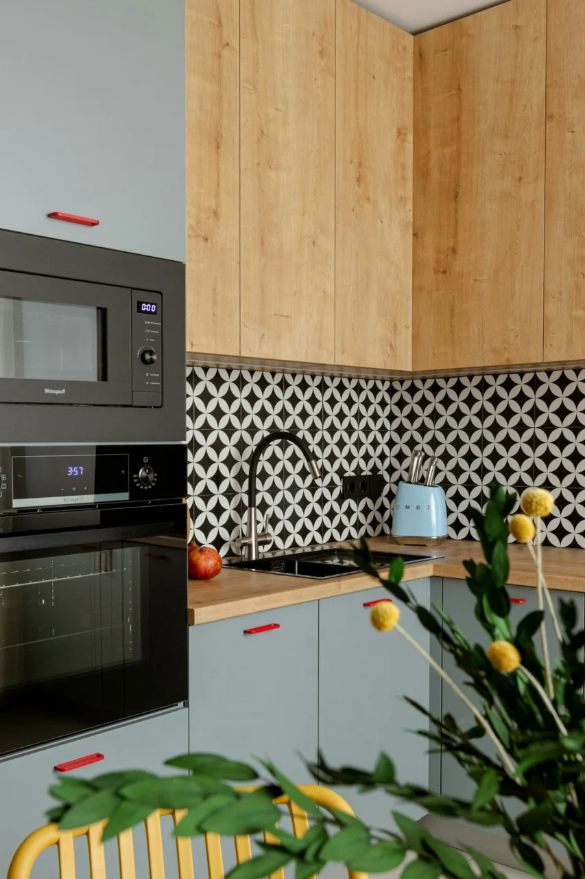 Modern kitchen with light wood cabinets and gray accents