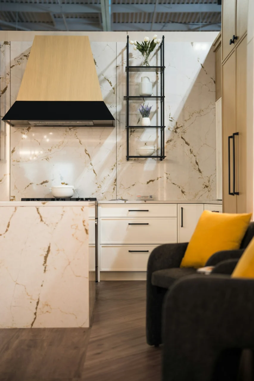 Modern kitchen with marble accents and yellow pillows