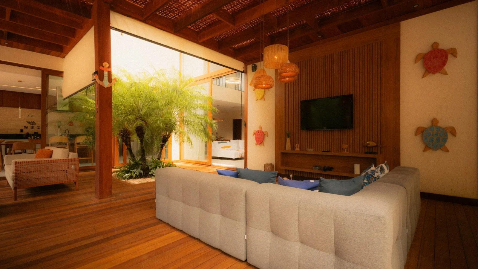 Modern living room with large couch and indoor plants
