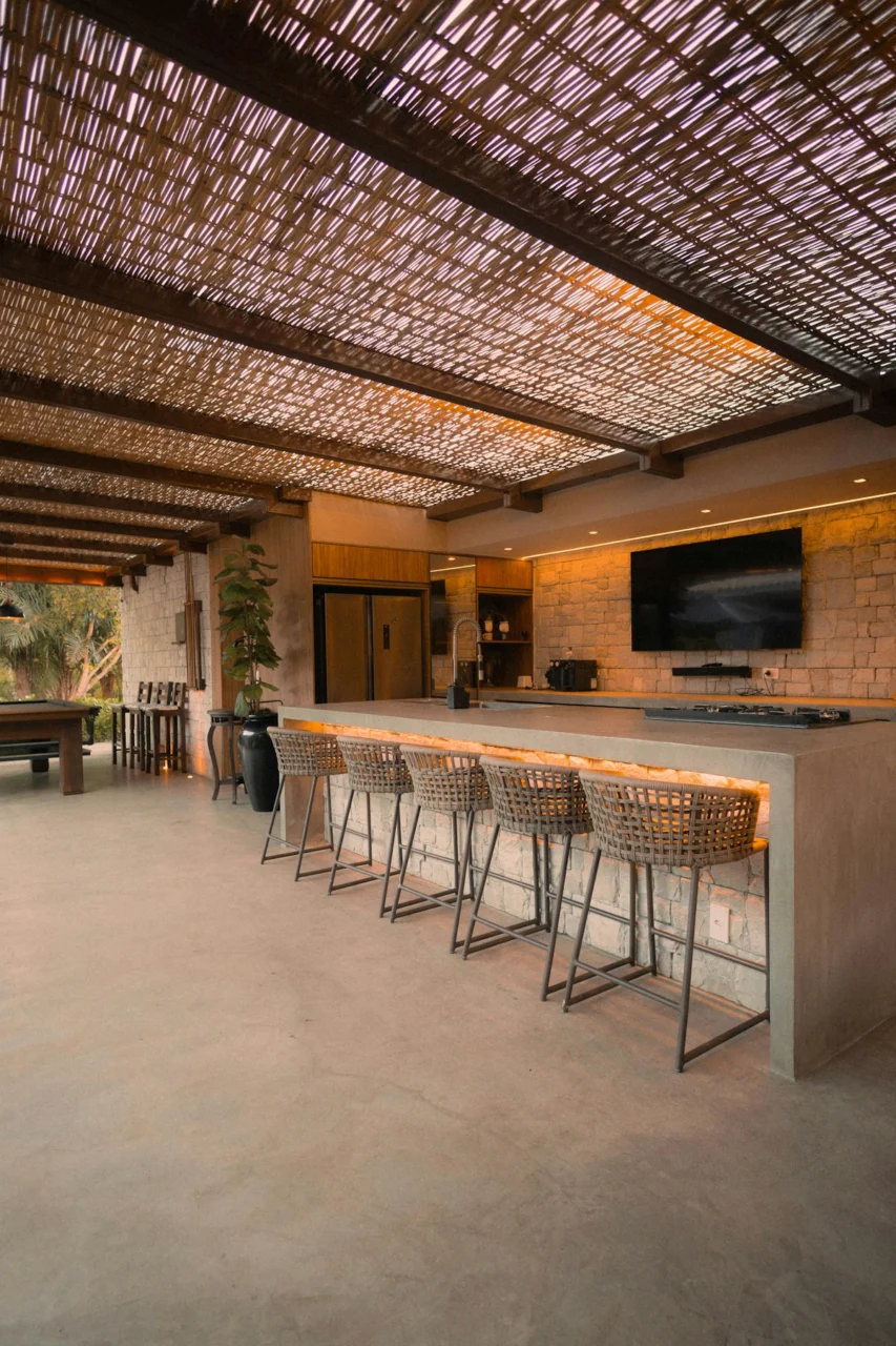 Modern outdoor kitchen with island and bar stools