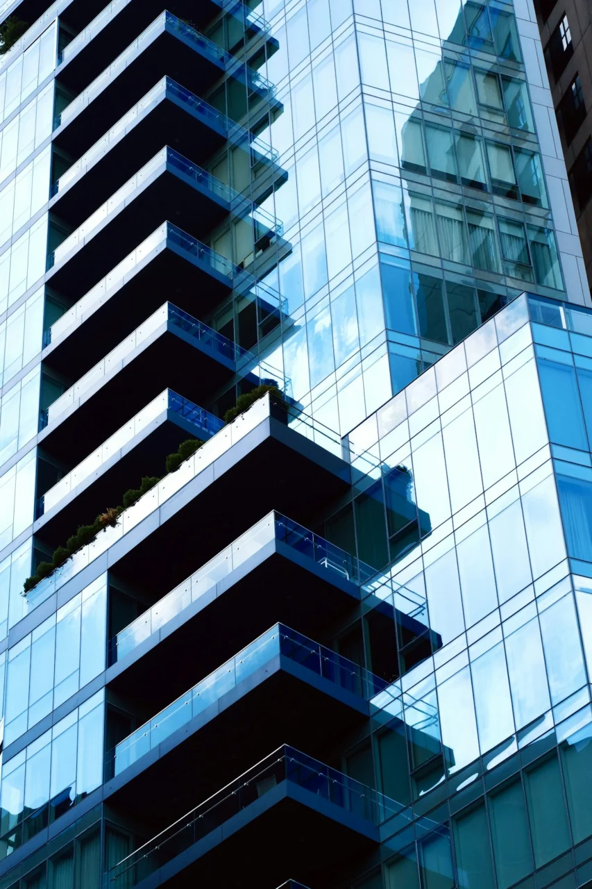 Modern skyscraper with blue glass windows and balconies