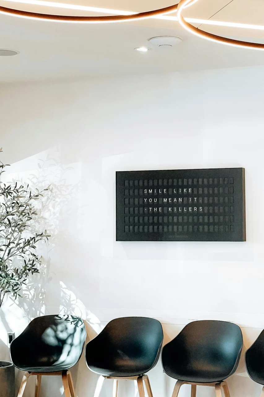 Modern waiting room with chairs and inspirational sign