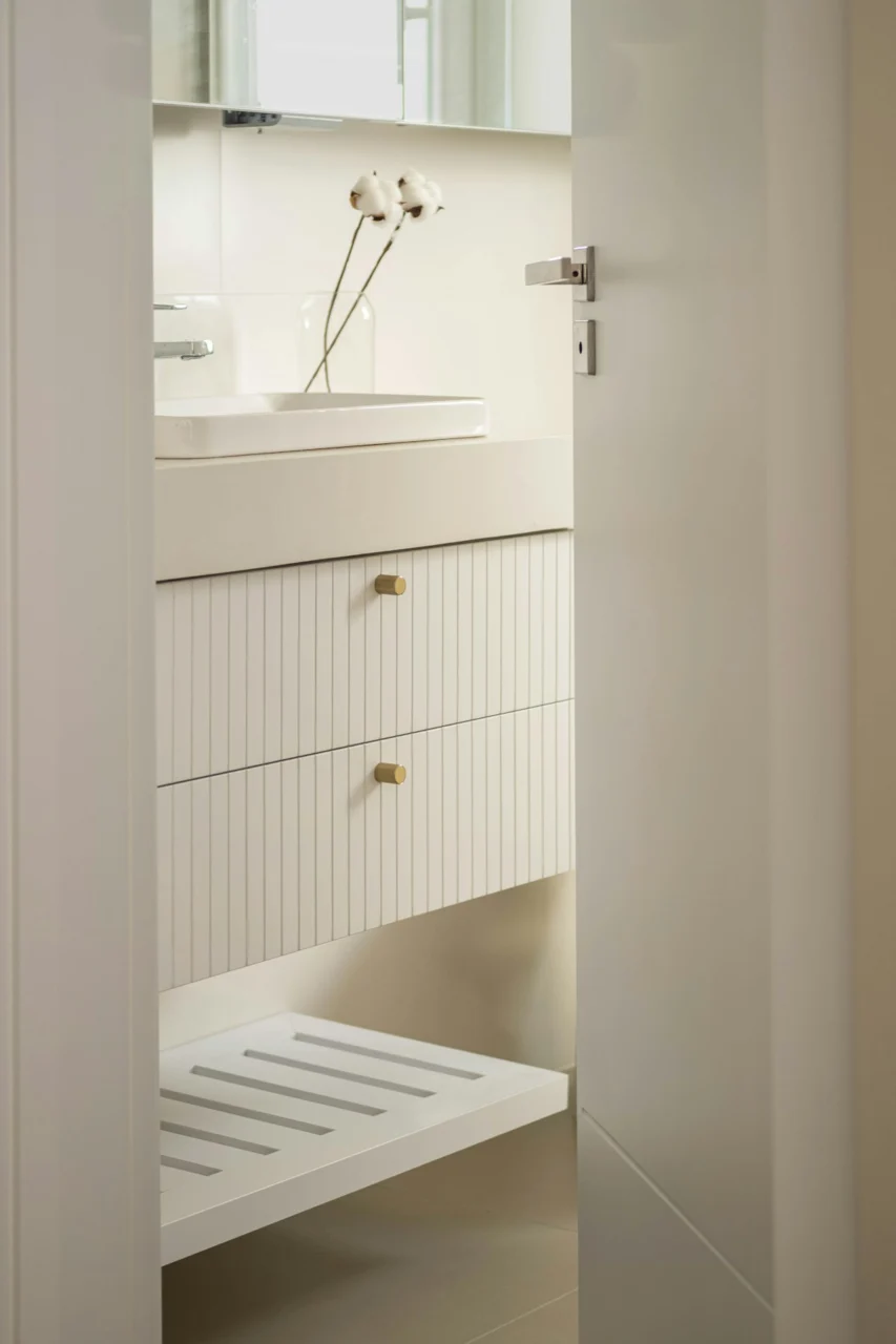 Modern white bathroom vanity with striped drawers