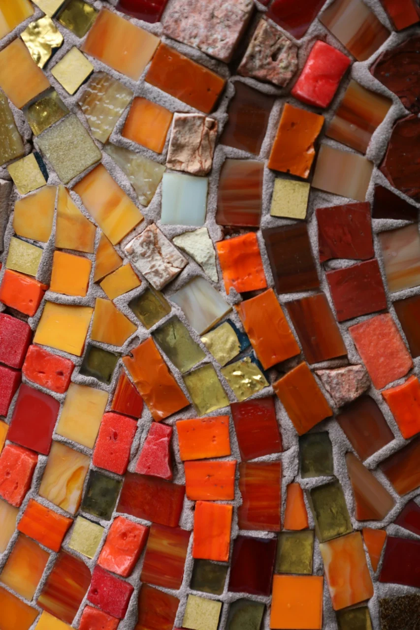 Mosaic tiles in warm colors create a textured pattern