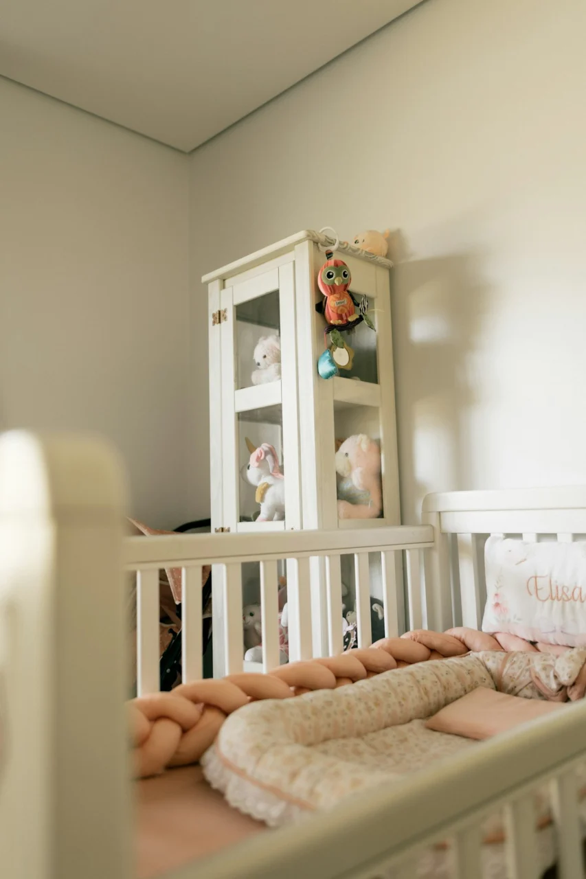 Nursery with crib and stuffed animals on shelf