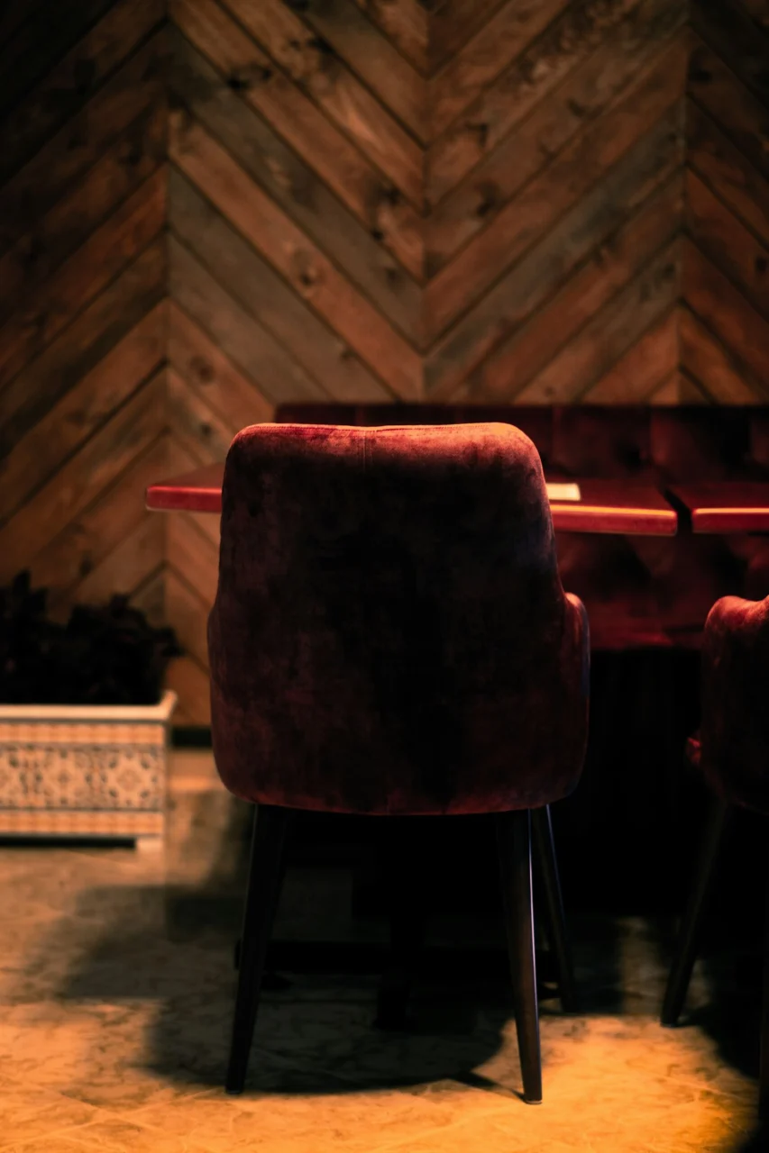 red and black chair on brown wooden floor