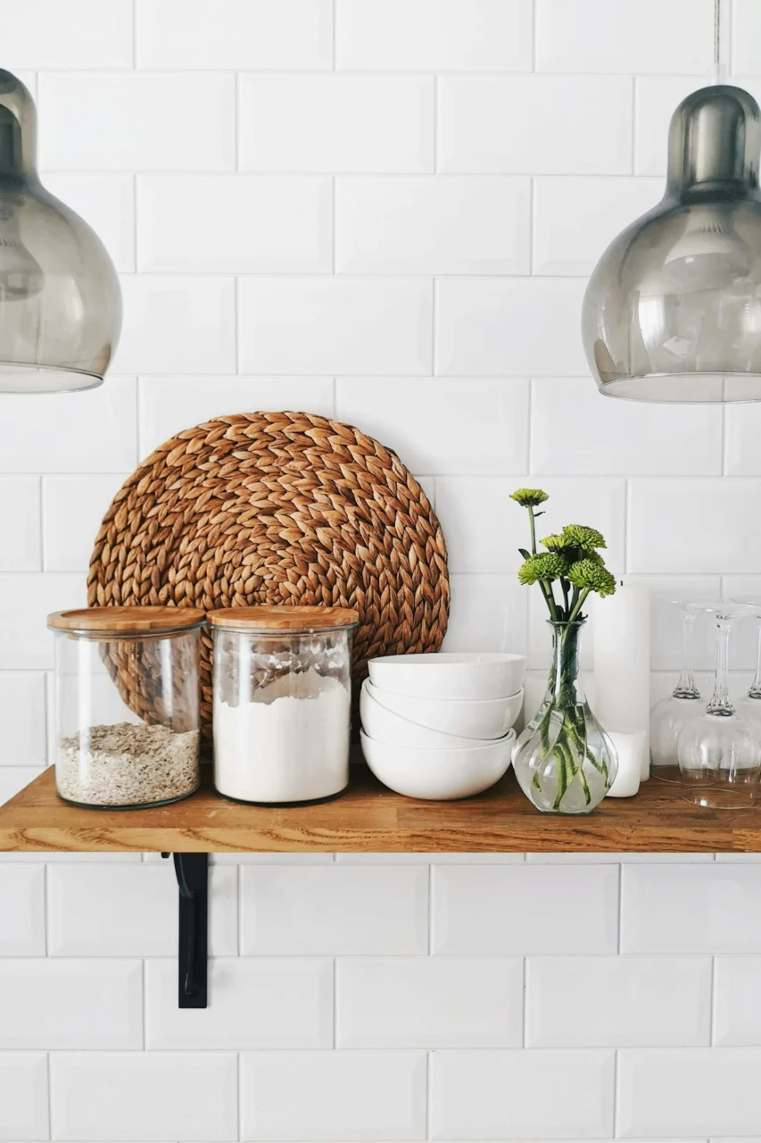 two clear glass jars on brown wooden floating shelf