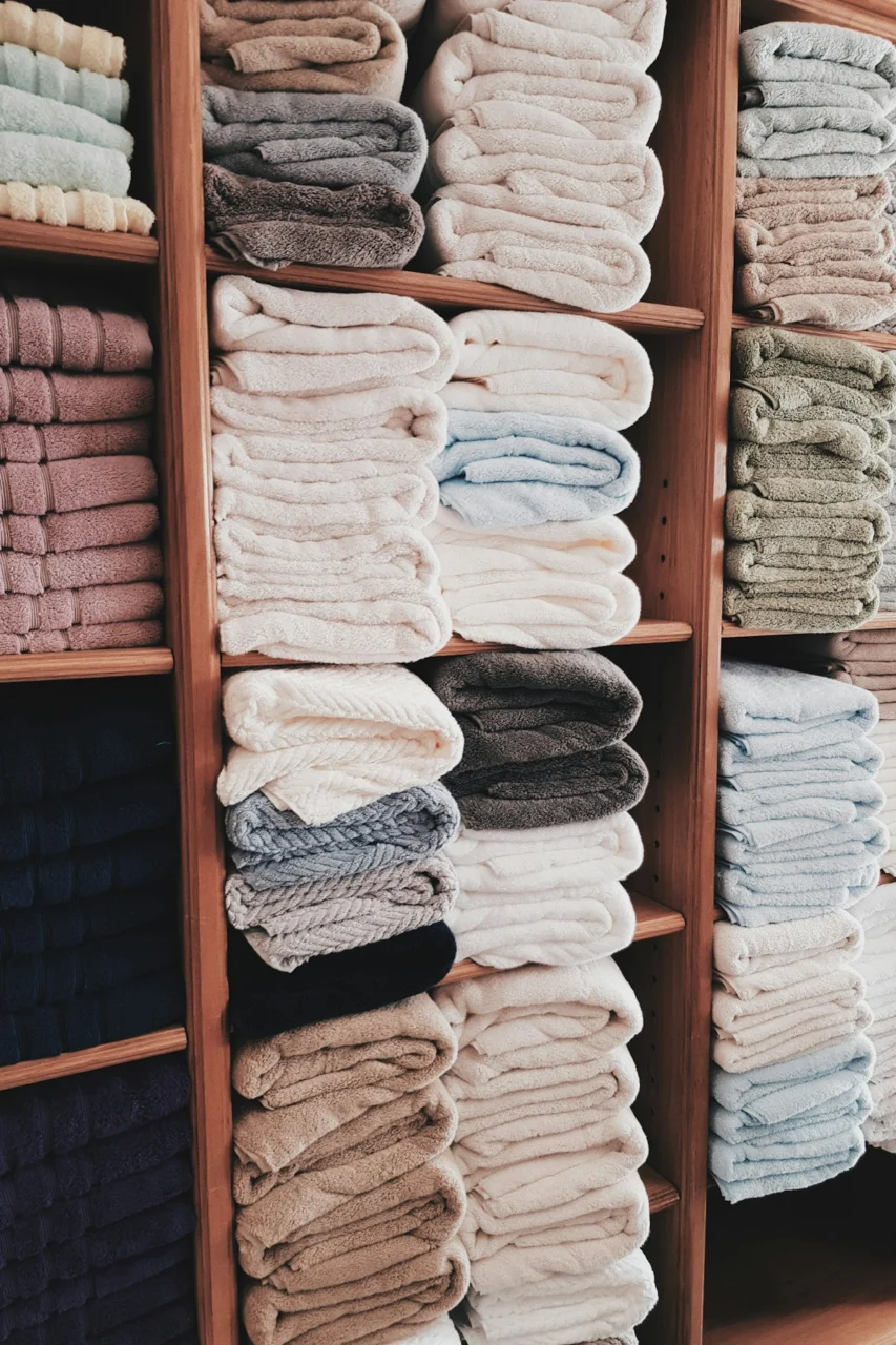 white and blue textile on brown wooden shelf