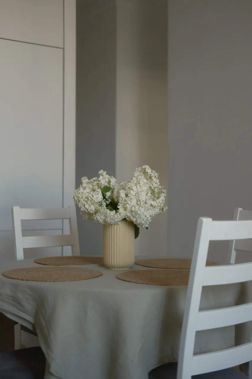 White flowers in a vase on a dining table