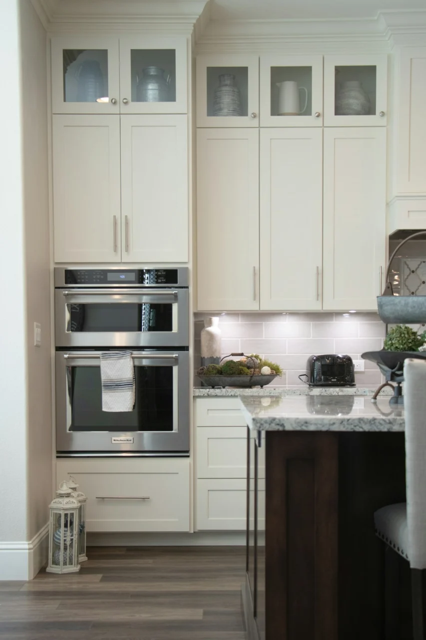 White wooden kitchen cabinet and stainless steel microwave oven